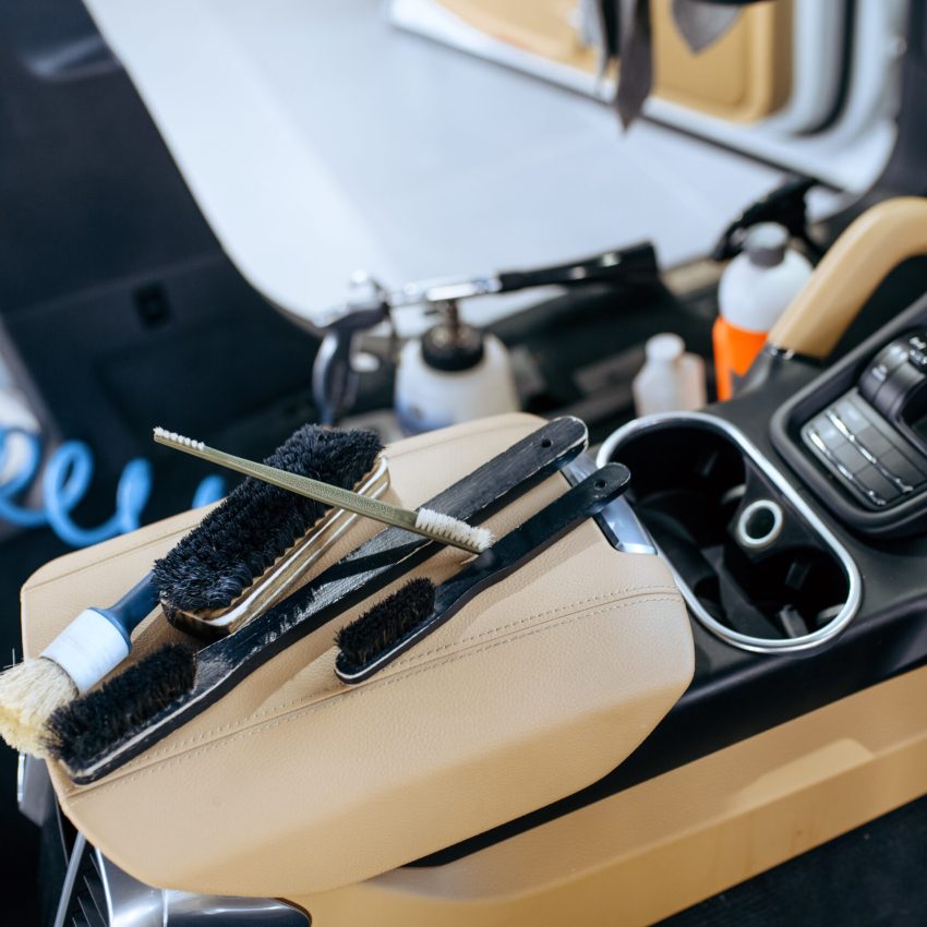 Car interior and brushes for dry cleaning and detailing, nobody. Vehicle washing, thoroughly care of automobile, chemical and vacuum clean service