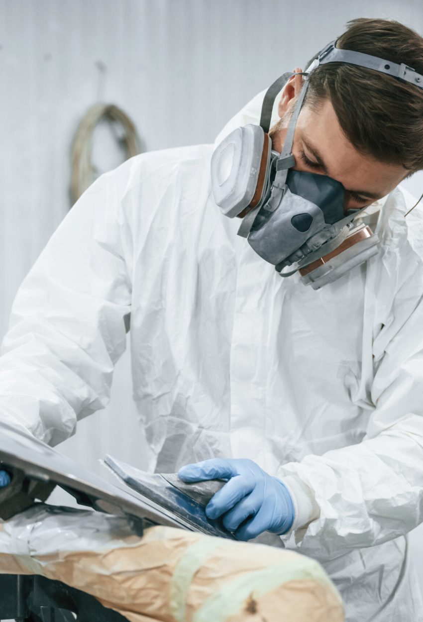Metal carcass. Repairman is working in the garage Metal carcass. Repairman is working in the garage.