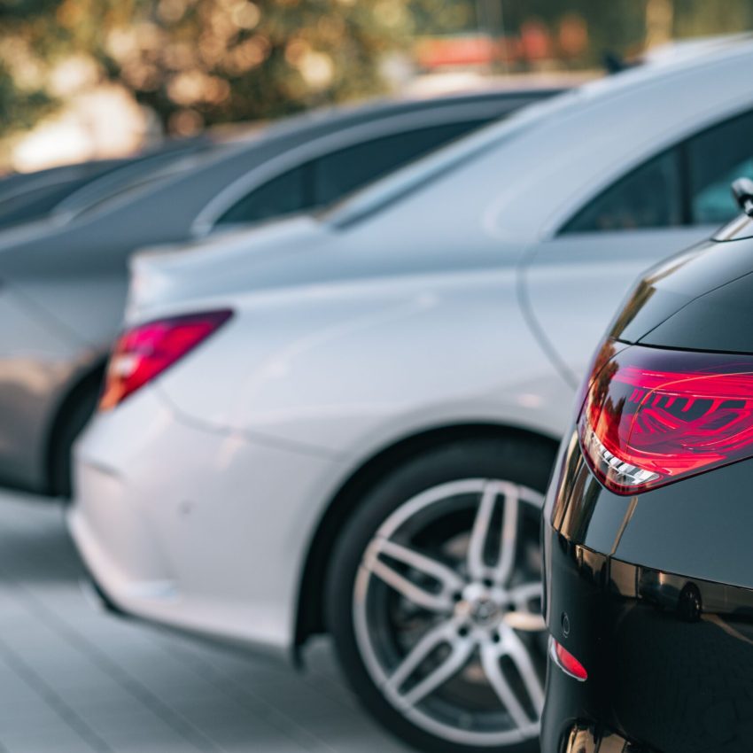 A selective focus view of different Mercedes-Benz cars parked in a row